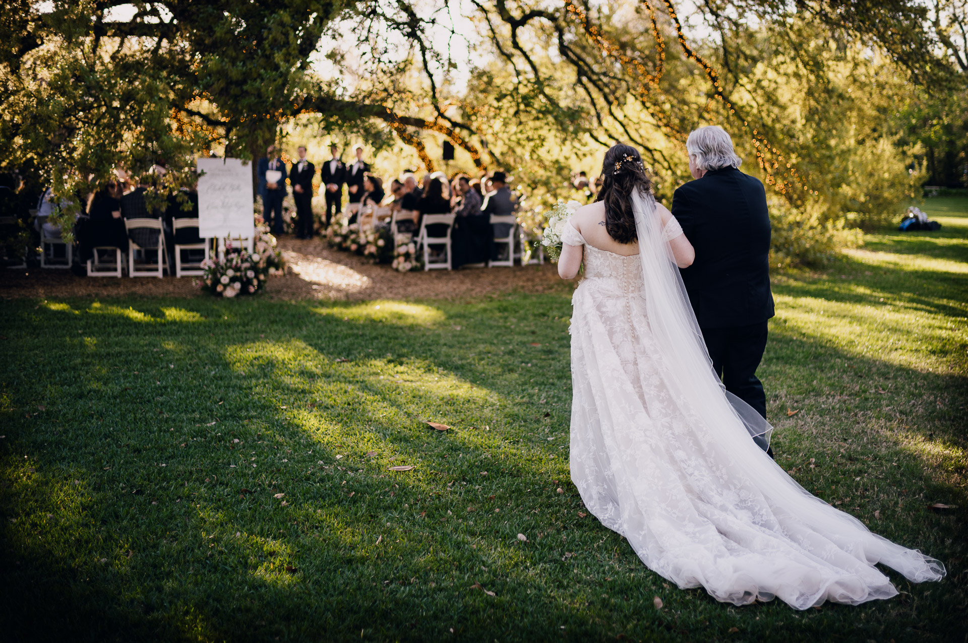 Oak Tree Ceremony & Candlelit Reception at The Houstonian 24 Bride walking across the lawn with her veil flowing behind her at The Houstonian Hotel.