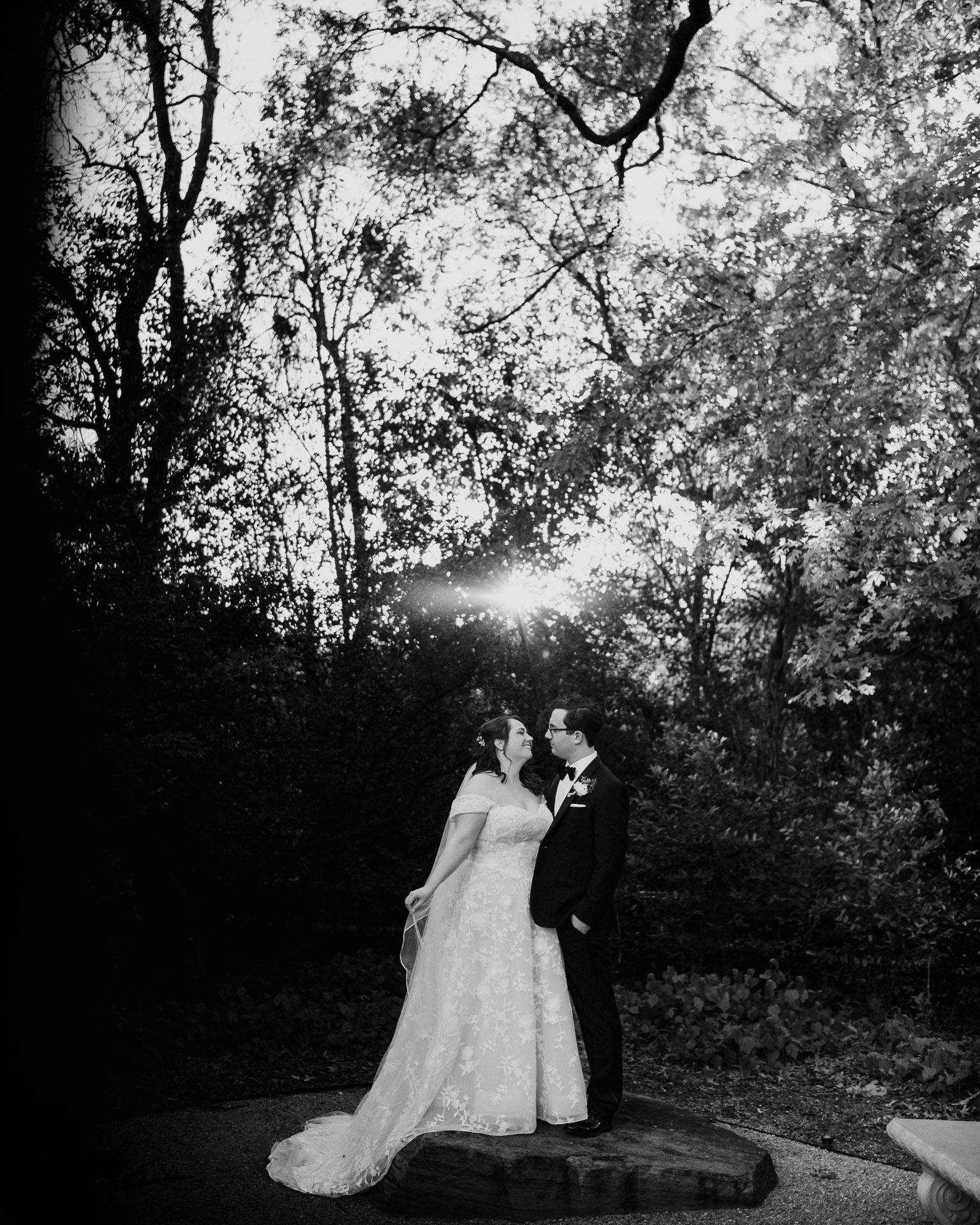 Oak Tree Ceremony & Candlelit Reception at The Houstonian 35 Black-and-white portrait of the bride and groom outdoors among the trees.
