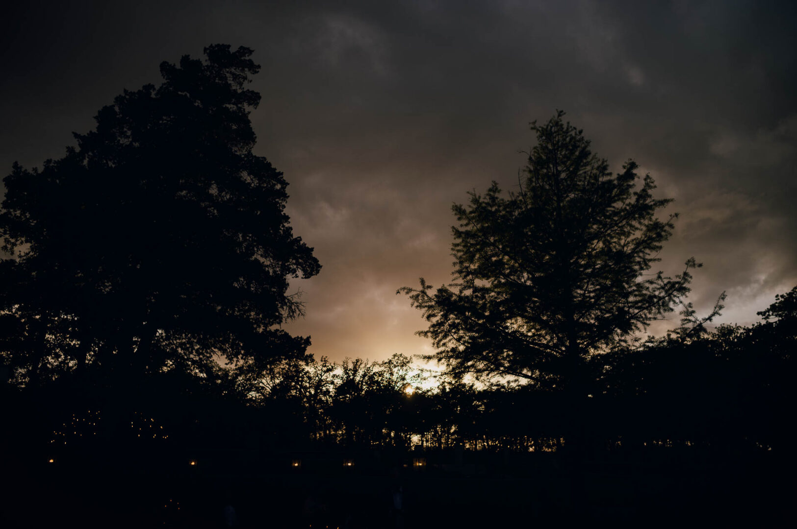 Vibrant Spring Wedding at Shiraz Gardens in Bastrop 50 Evening landscape photo of trees and dramatic clouds after a wedding ceremony at Shiraz Gardens in Bastrop, Texas.