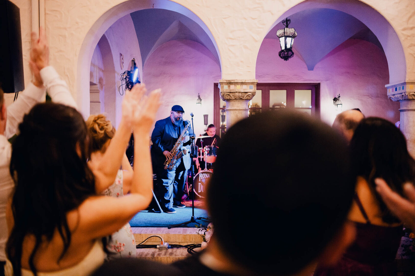 Wedding guests dancing in front of the live band during the reception.