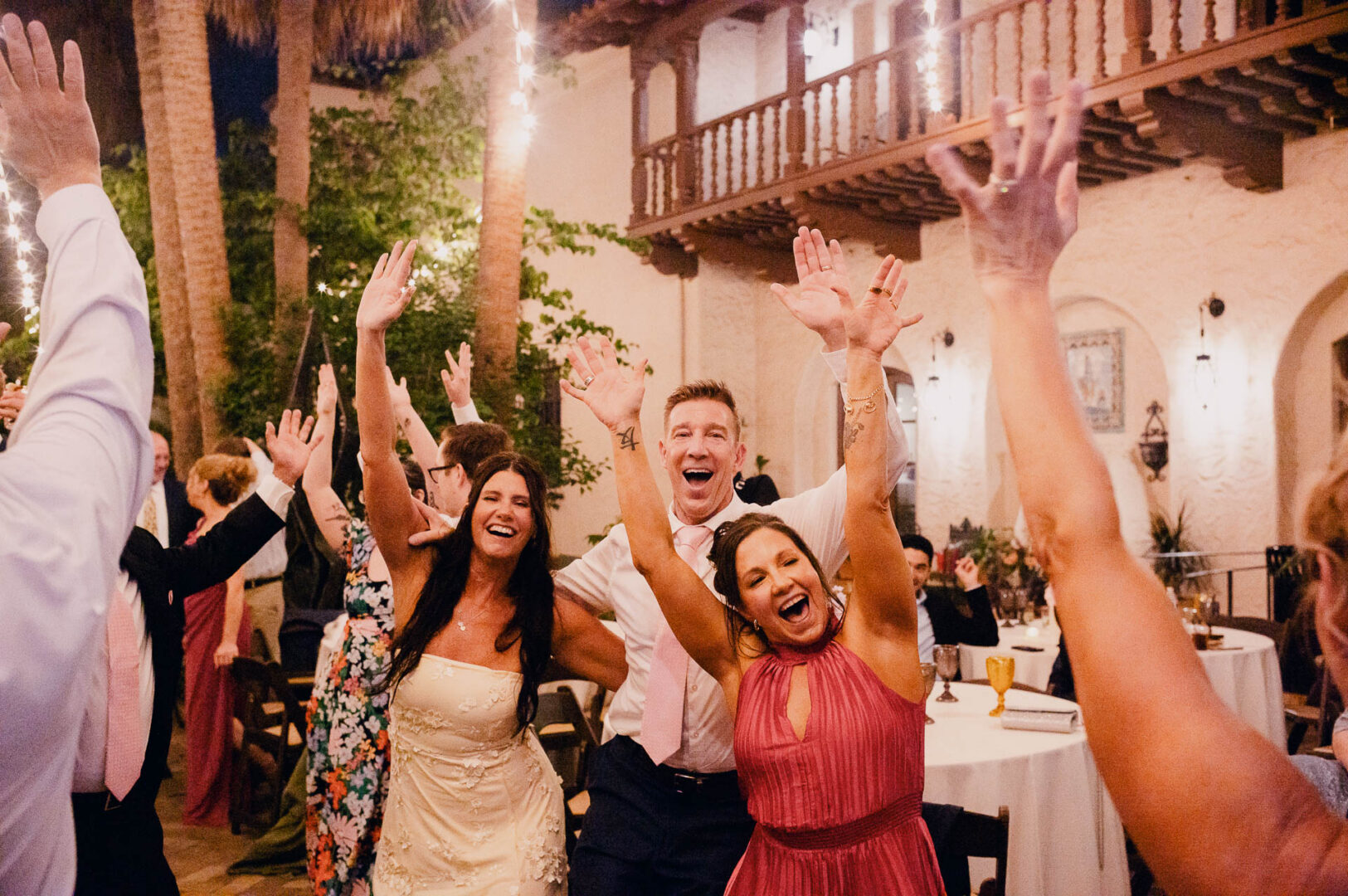 Bride and bridesmaids celebrating on the dance floor during the reception.