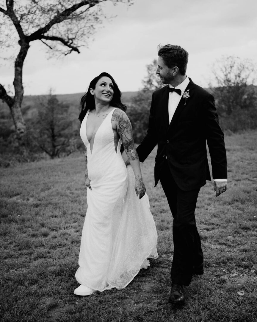 Vibrant Spring Wedding at Shiraz Gardens in Bastrop 61 Black and white wedding portrait of the bride and groom standing together outdoors at Shiraz Gardens in Bastrop, Texas.