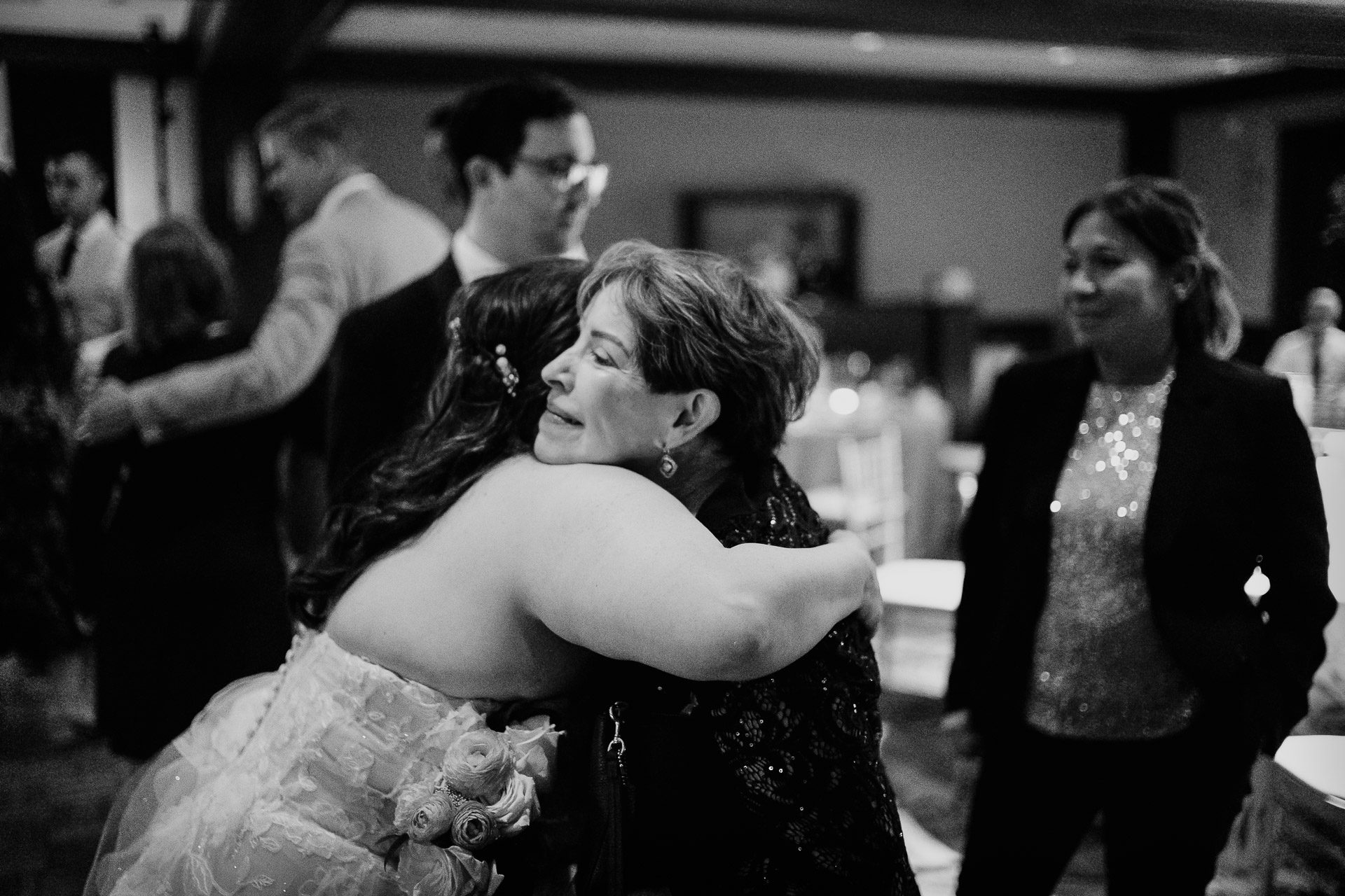 Oak Tree Ceremony & Candlelit Reception at The Houstonian 53 Emotional embrace at a wedding celebration.