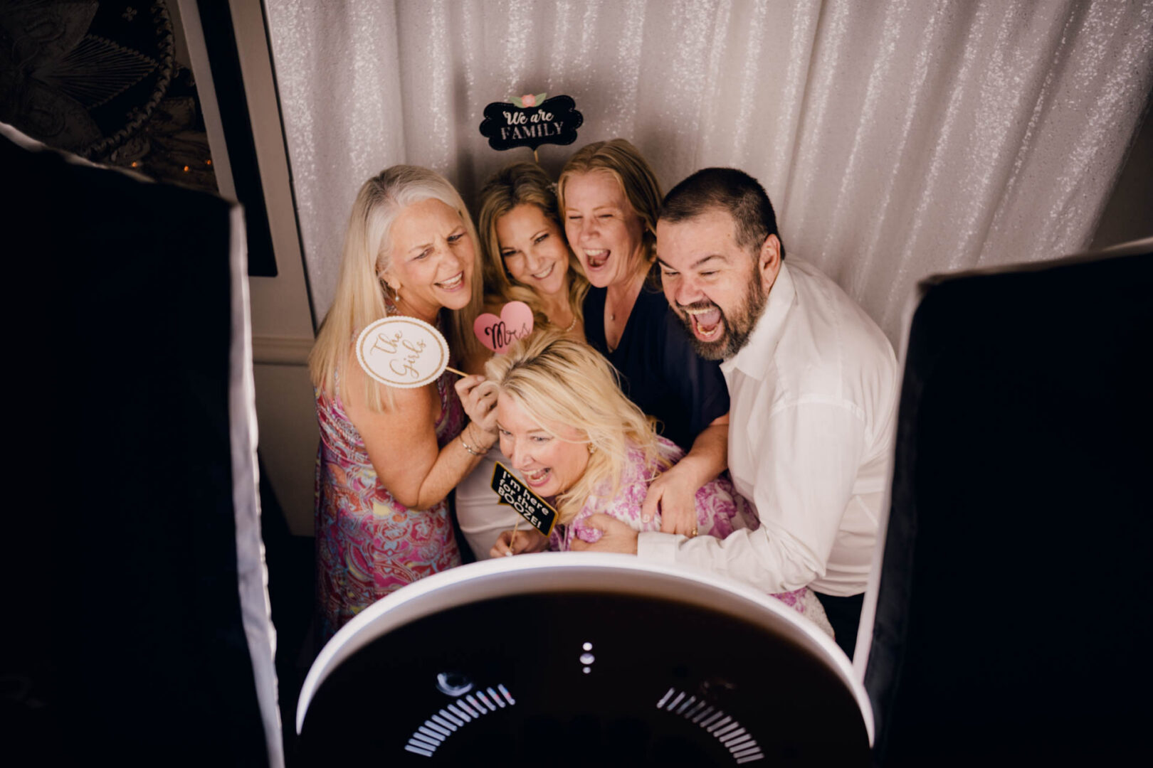 Group of wedding guests smiling together in photo booth at Omni La Mansión del Rio reception