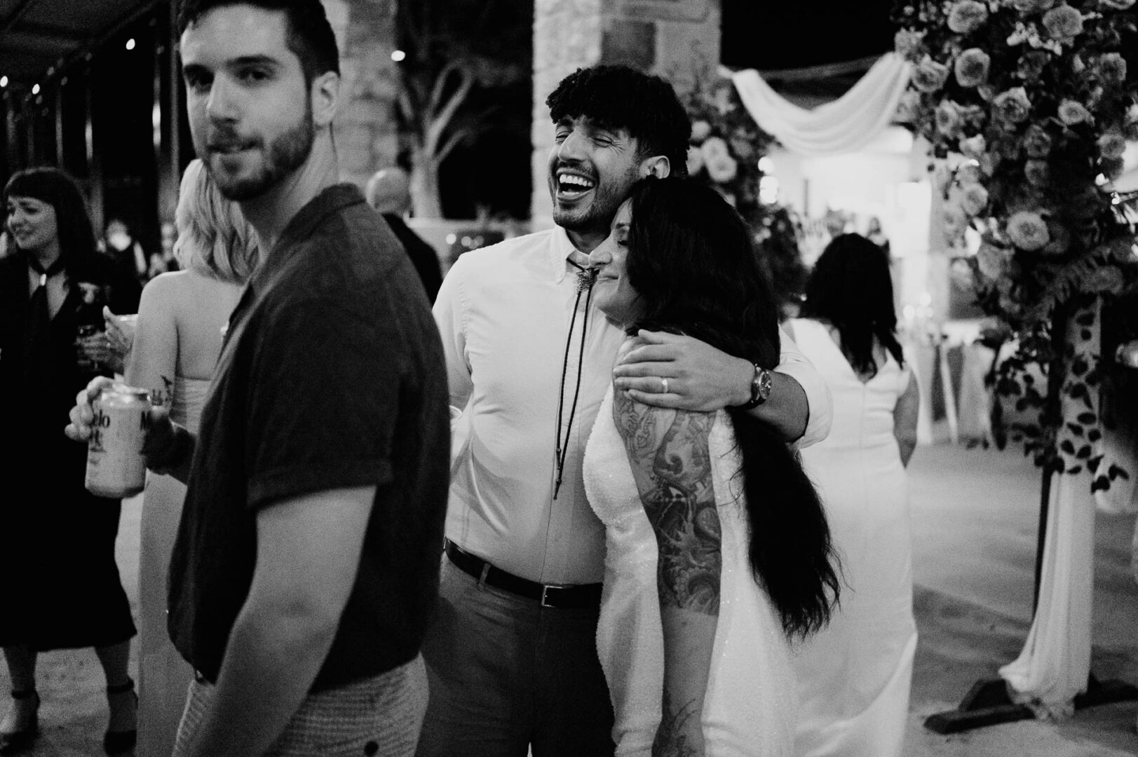 Vibrant Spring Wedding at Shiraz Gardens in Bastrop 73 Black and white documentary wedding photo of guests mingling during the reception at Shiraz Gardens in Bastrop, Texas.
