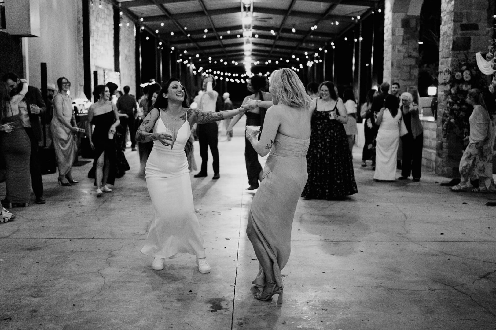 Vibrant Spring Wedding at Shiraz Gardens in Bastrop 76 Black and white documentary wedding photo of the bride and groom dancing during the reception at Shiraz Gardens in Bastrop, Texas.
