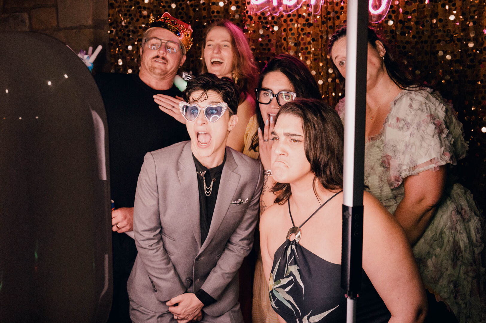Vibrant Spring Wedding at Shiraz Gardens in Bastrop 77 Candid wedding reception photo of guests smiling together in a photo booth-style moment at Shiraz Gardens in Bastrop, Texas.