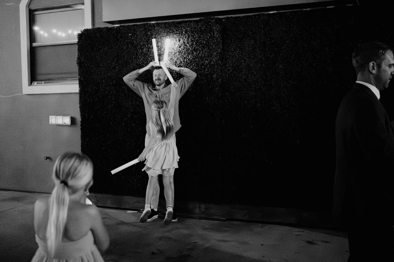 Vibrant Spring Wedding at Shiraz Gardens in Bastrop 79 Black and white documentary wedding photo of a child dancing during the reception at Shiraz Gardens in Bastrop, Texas.
