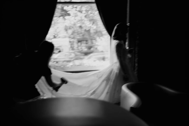 Black and white silhouette from inside The Metropolitan Club during the wedding day.