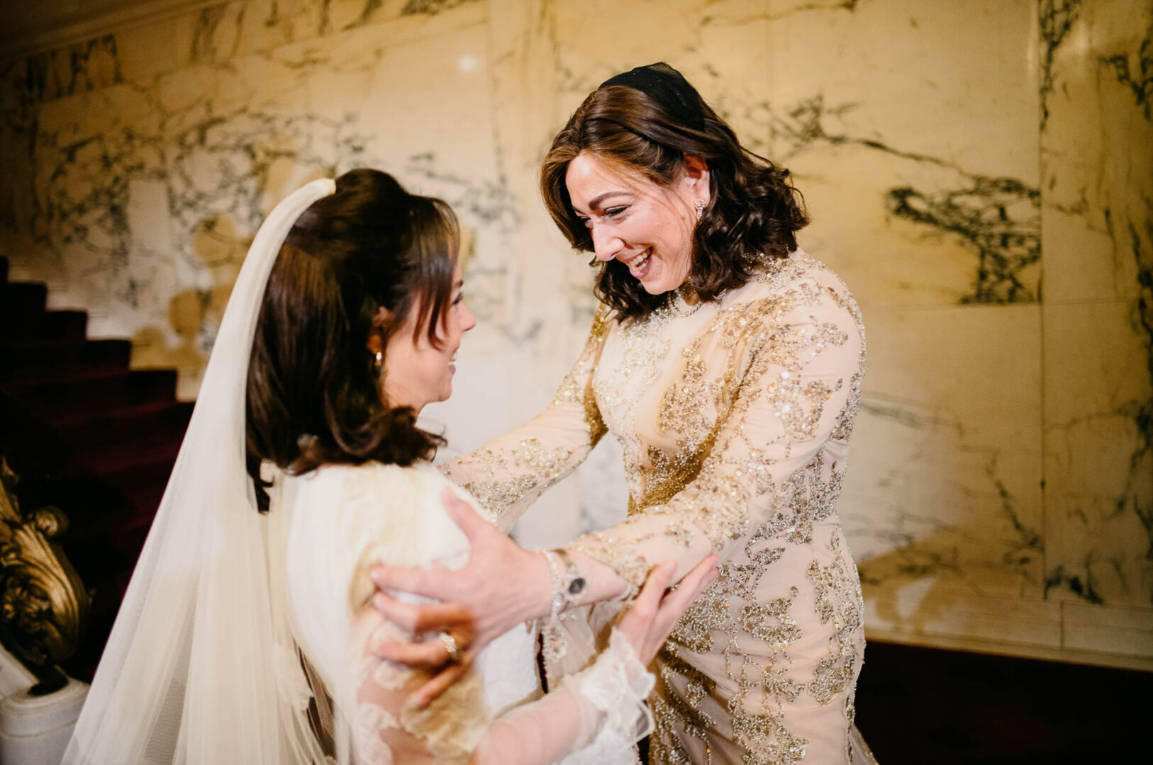 Bride sharing a quiet moment with family before the ceremony.