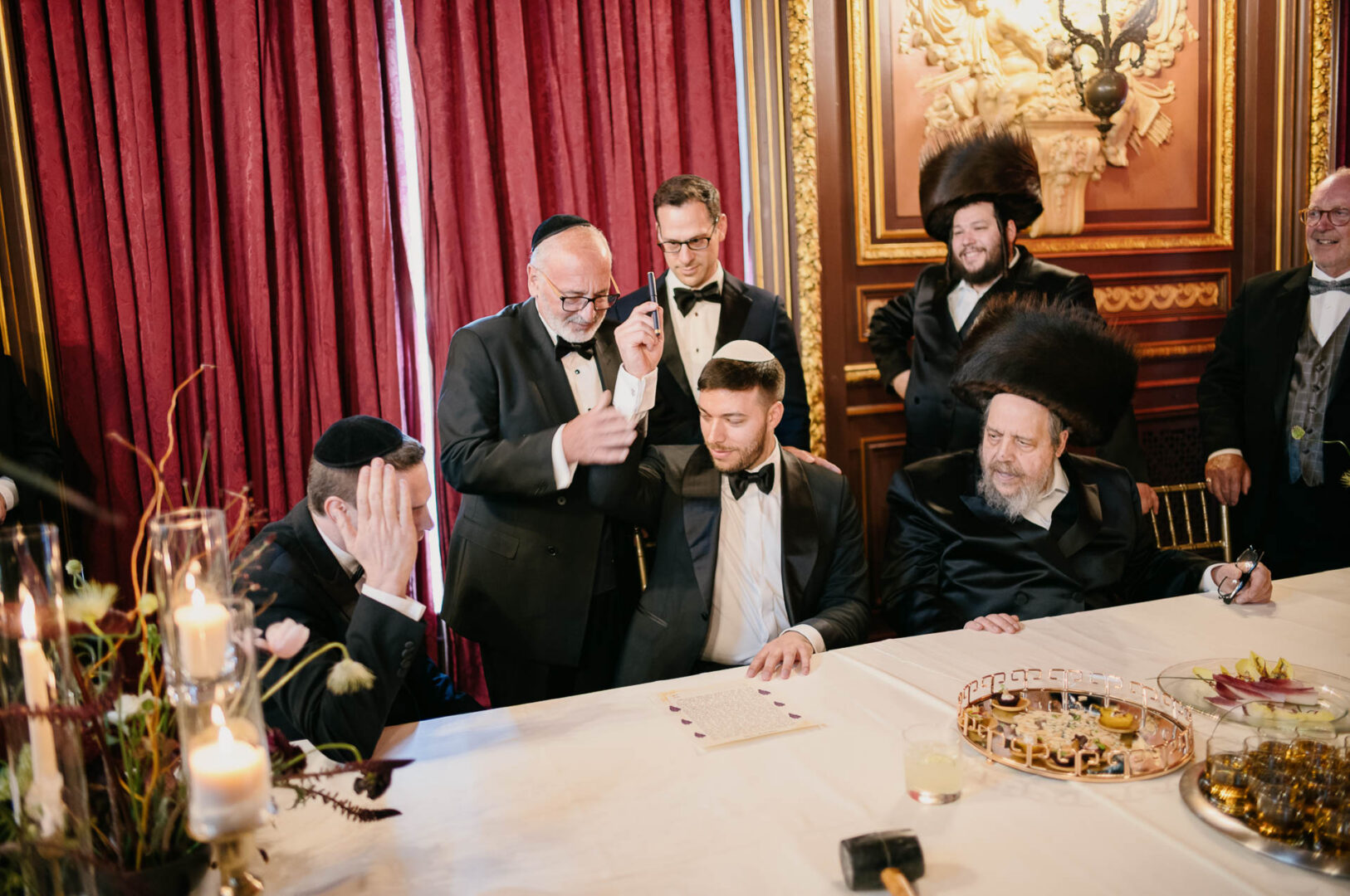 Groom with family and guests during Orthodox Jewish wedding traditions.