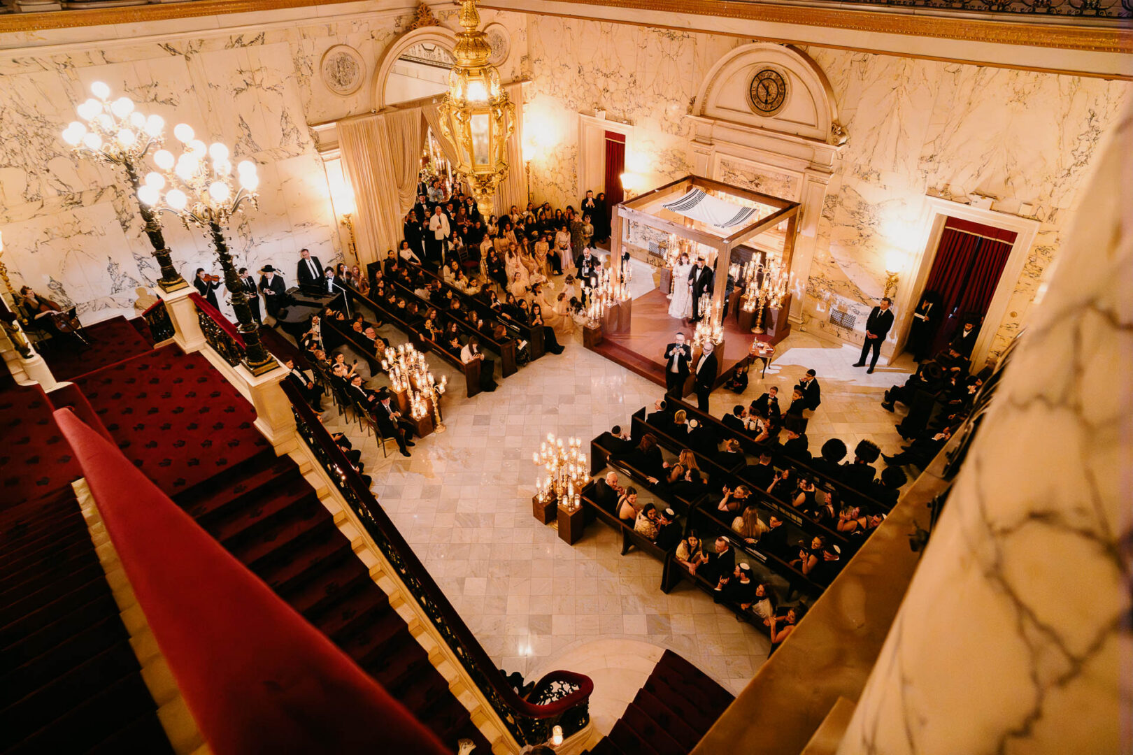 Overhead view of the bride, groom, and family beneath the chuppah.