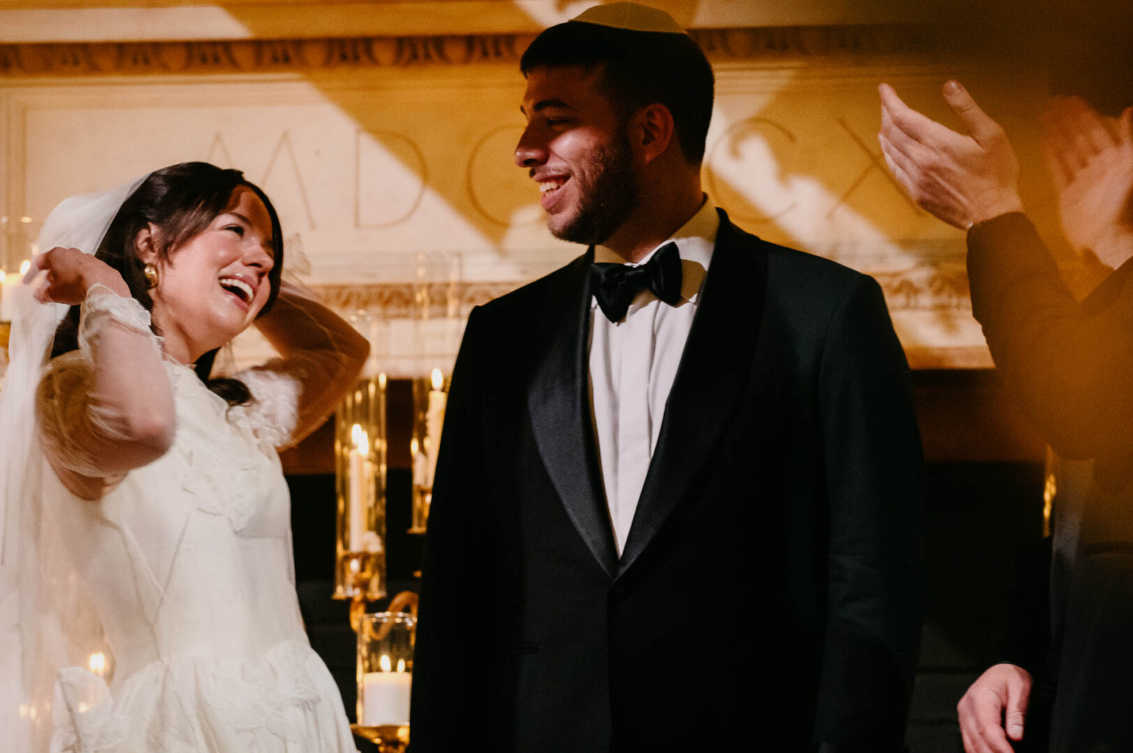 Couple smiling during wedding ceremony.