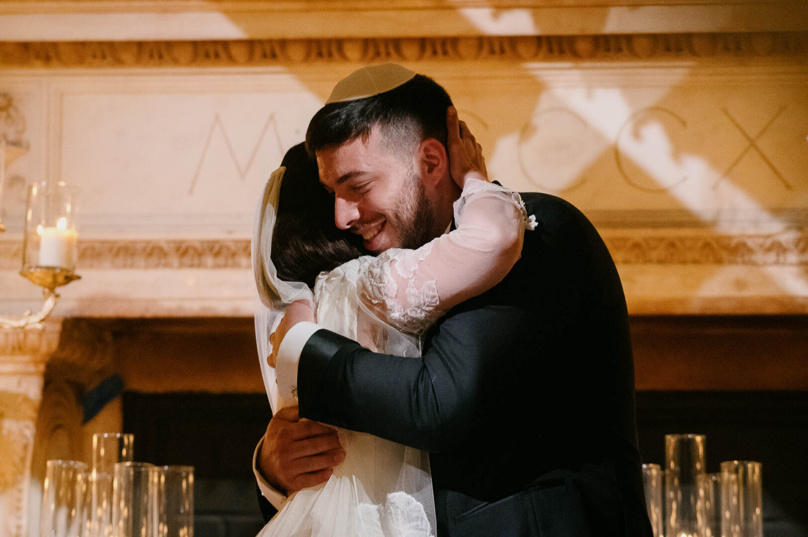 Couple embracing during wedding ceremony.
