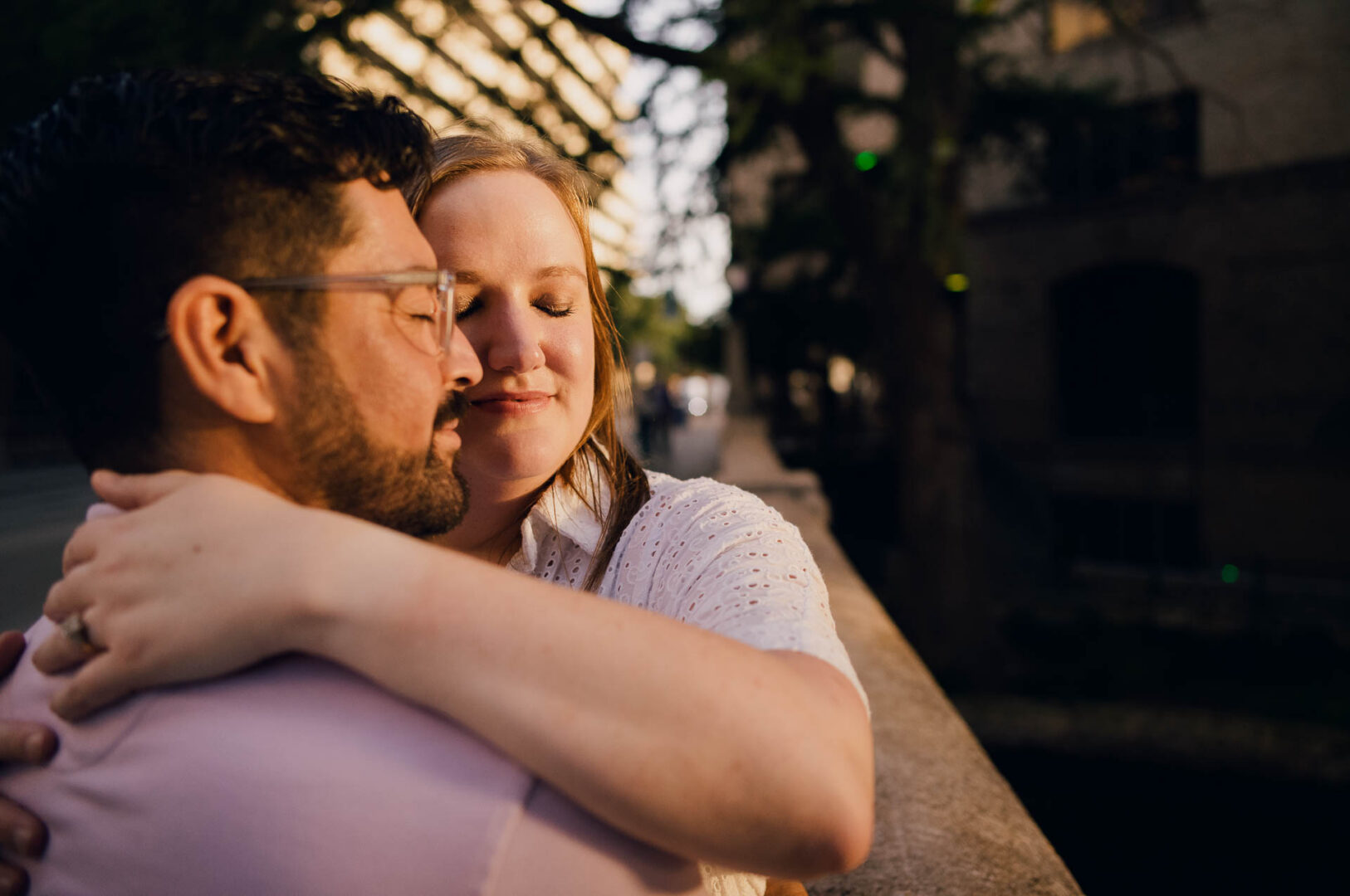 Couple embracing in romantic setting.