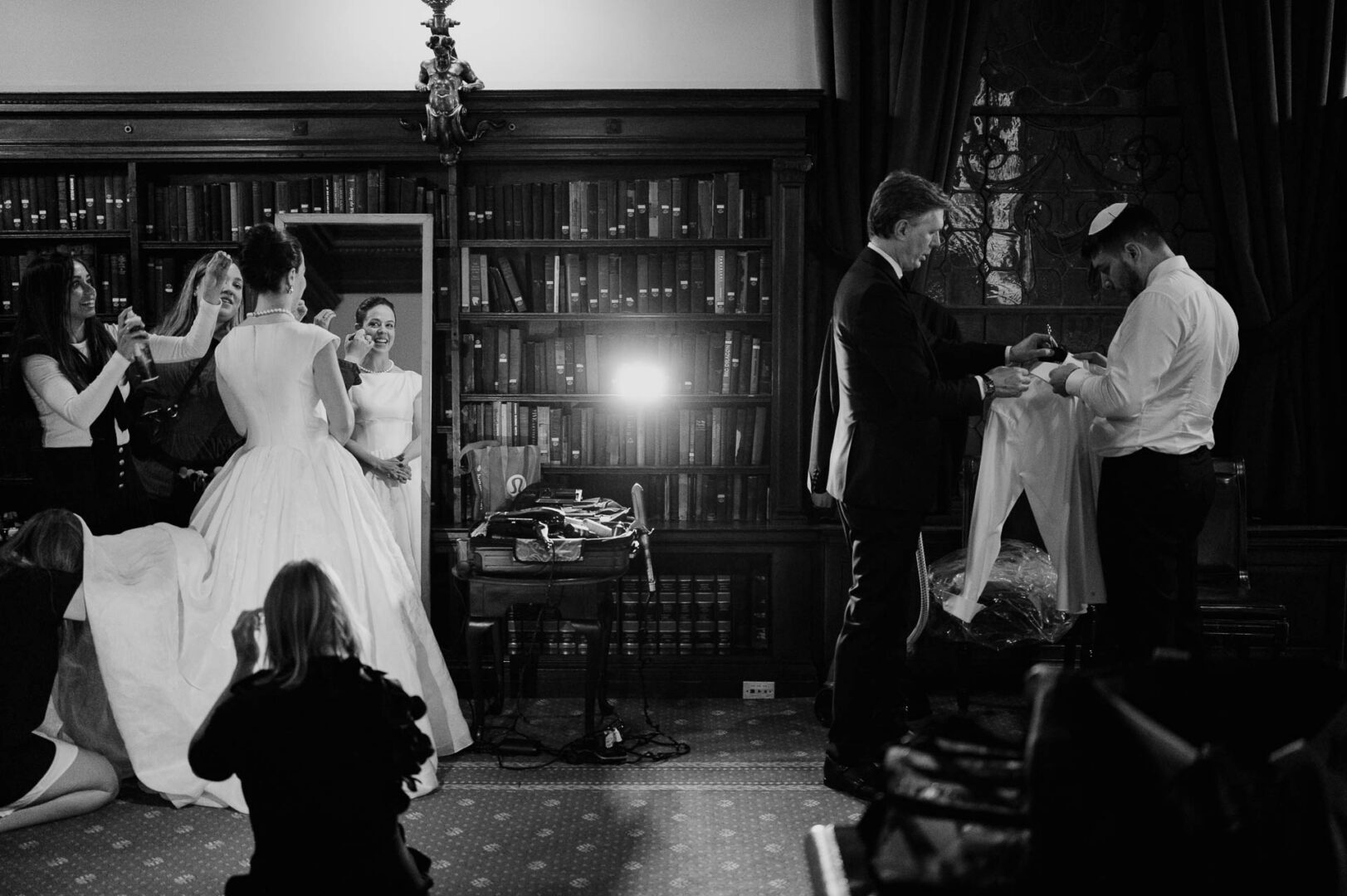 Wedding preparations in elegant library setting.