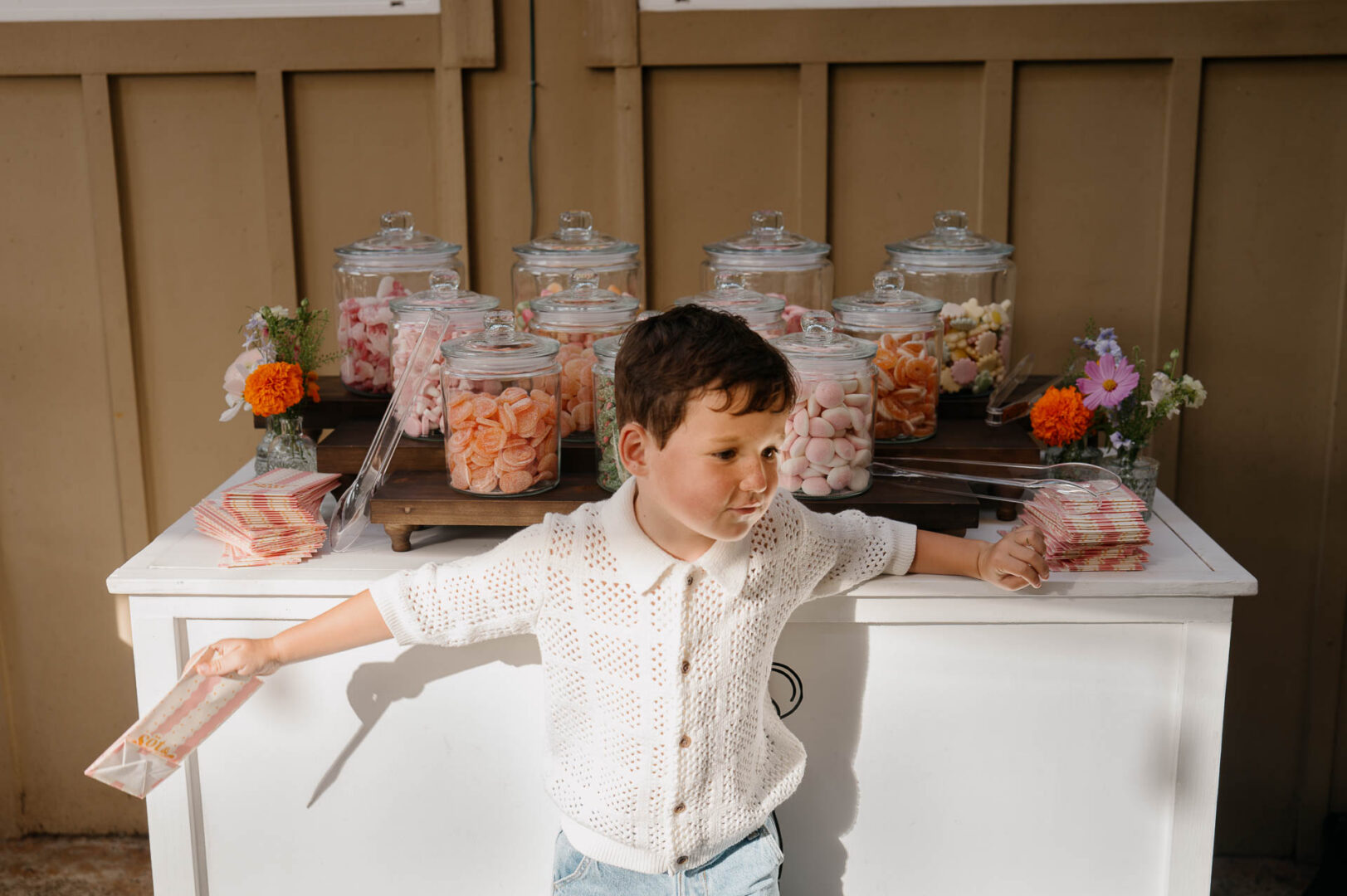Young guest protects the desert table during a wedding at The Kendall in Boerne.