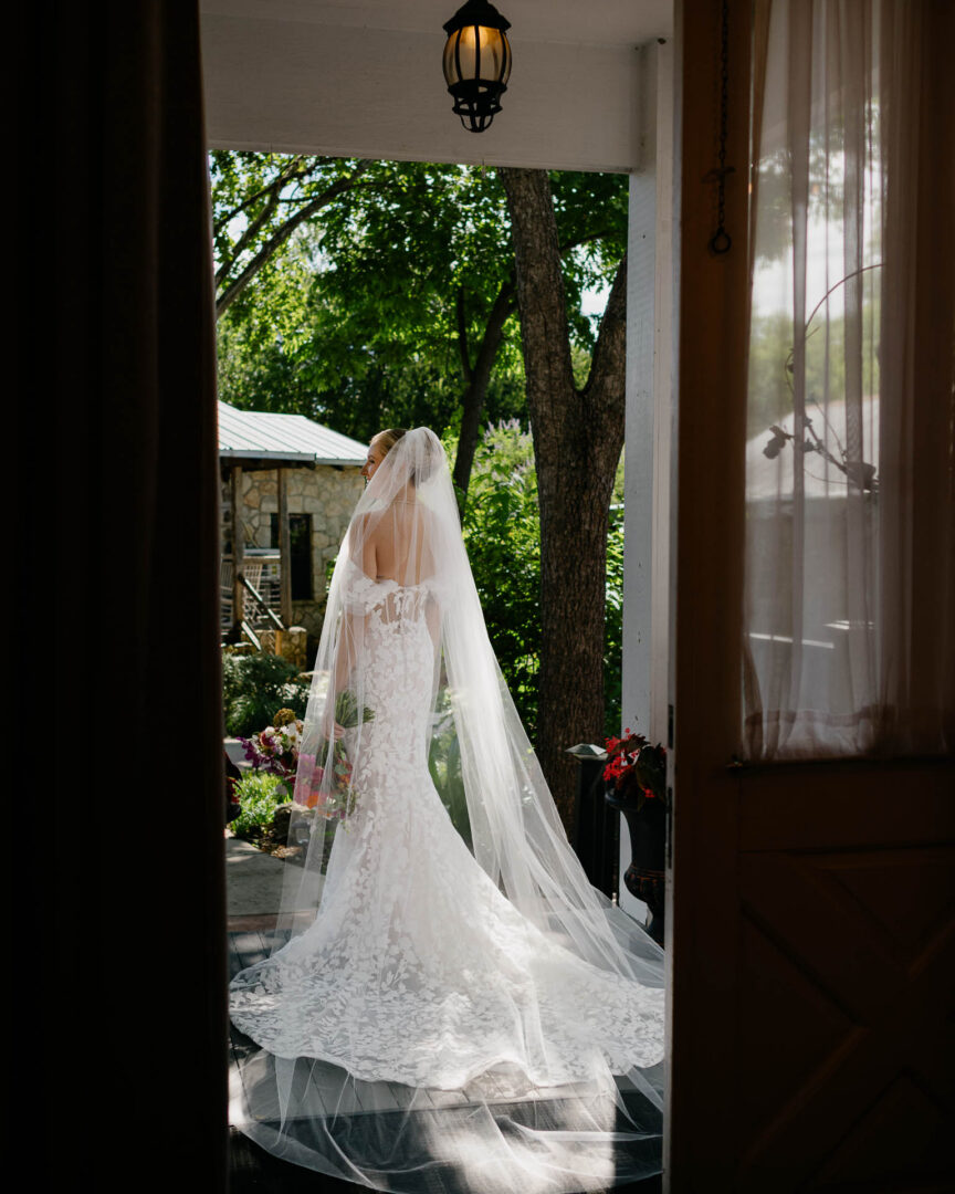 Bride standing quietly in a doorway before the ceremony at The Kendall.
