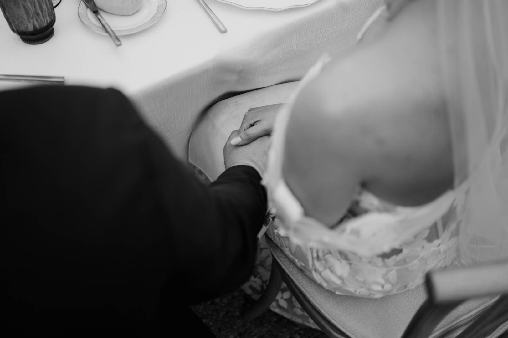 Black-and-white bride and groom holding hands