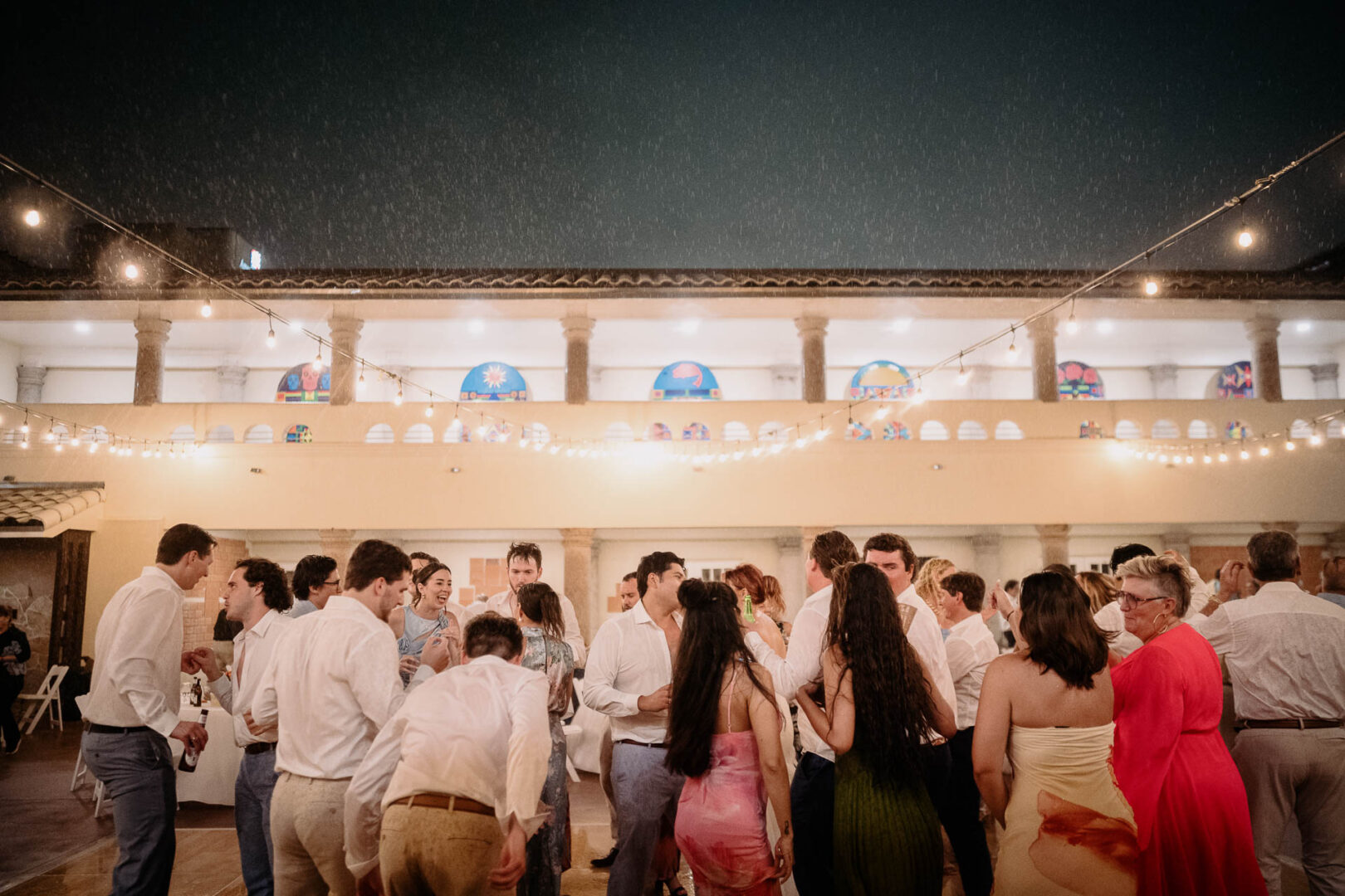 Chapel on the Dunes Wedding | Port Aransas, Texas | Mady+Roland 67 Wedding reception with guests dancing in the rain