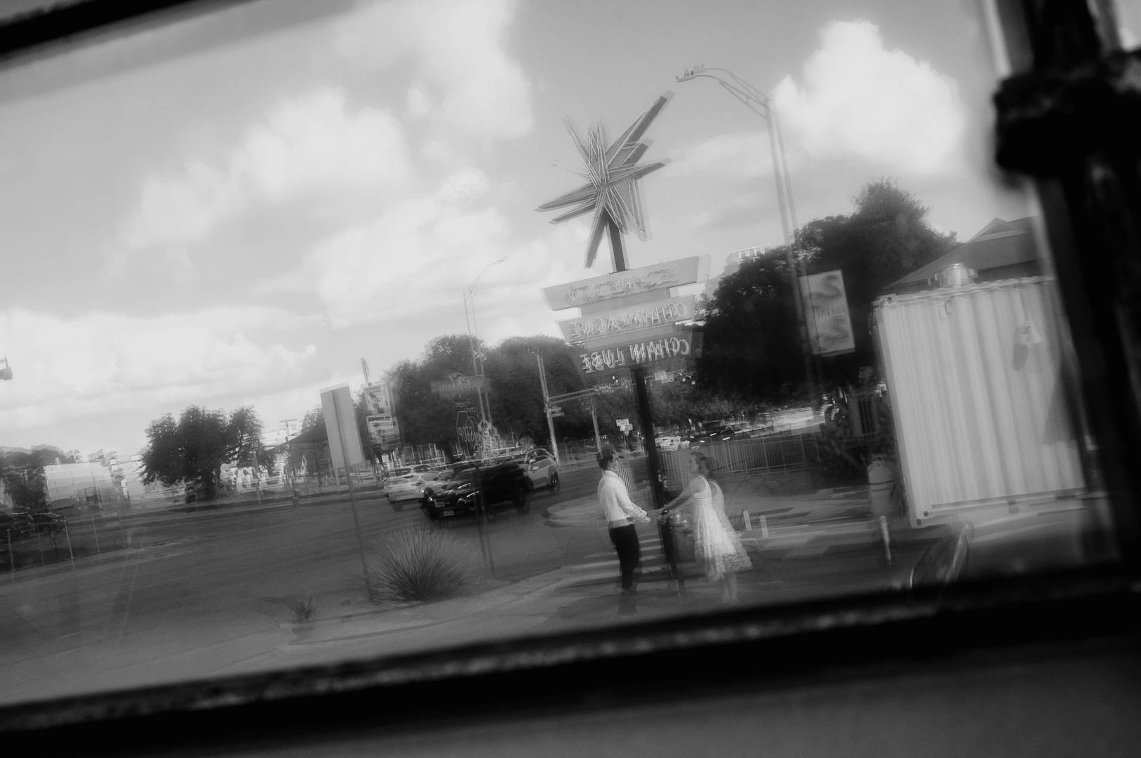 Couple walking near retro sign.