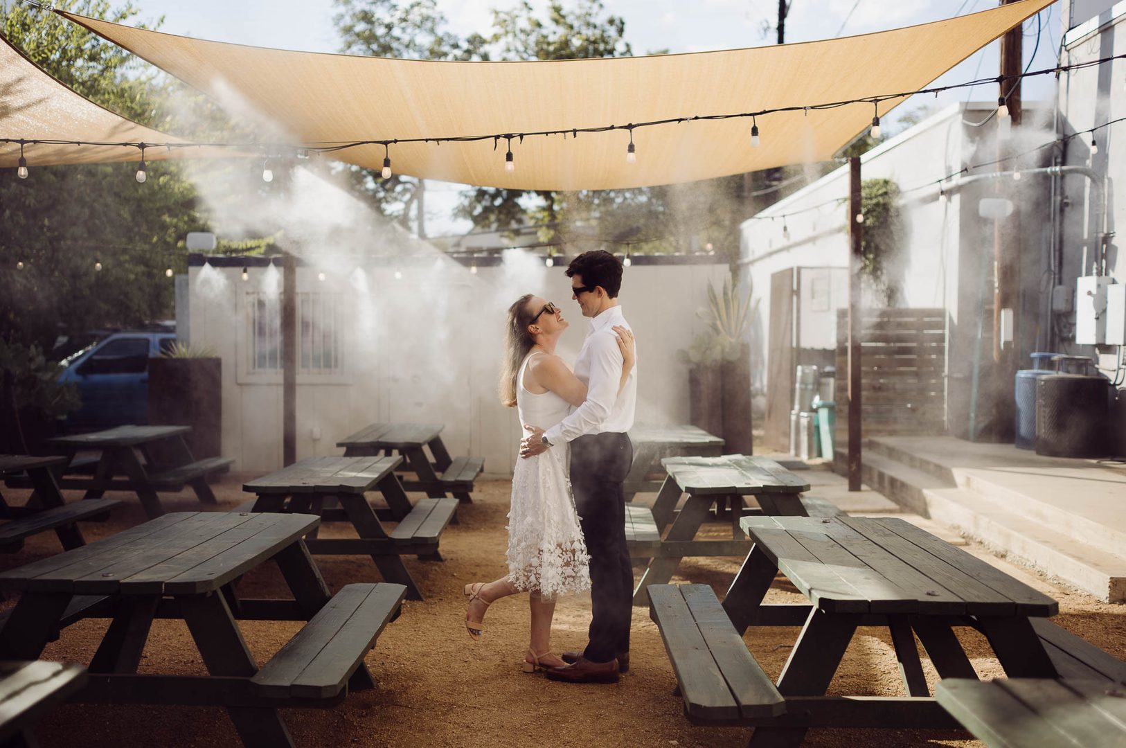 Couple dancing in misty outdoor setting