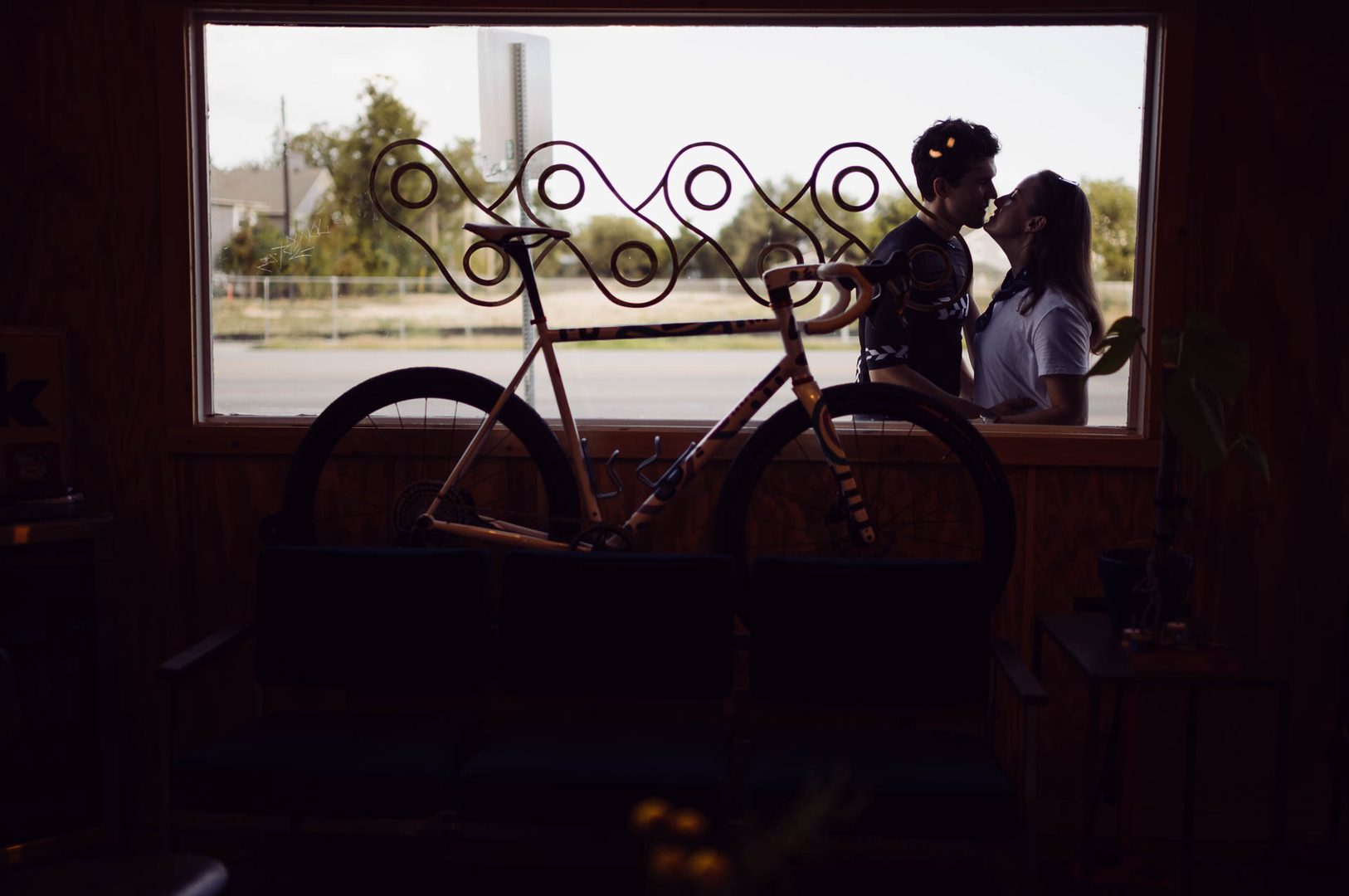 Couple kissing with bicycle silhouette at The Meteor