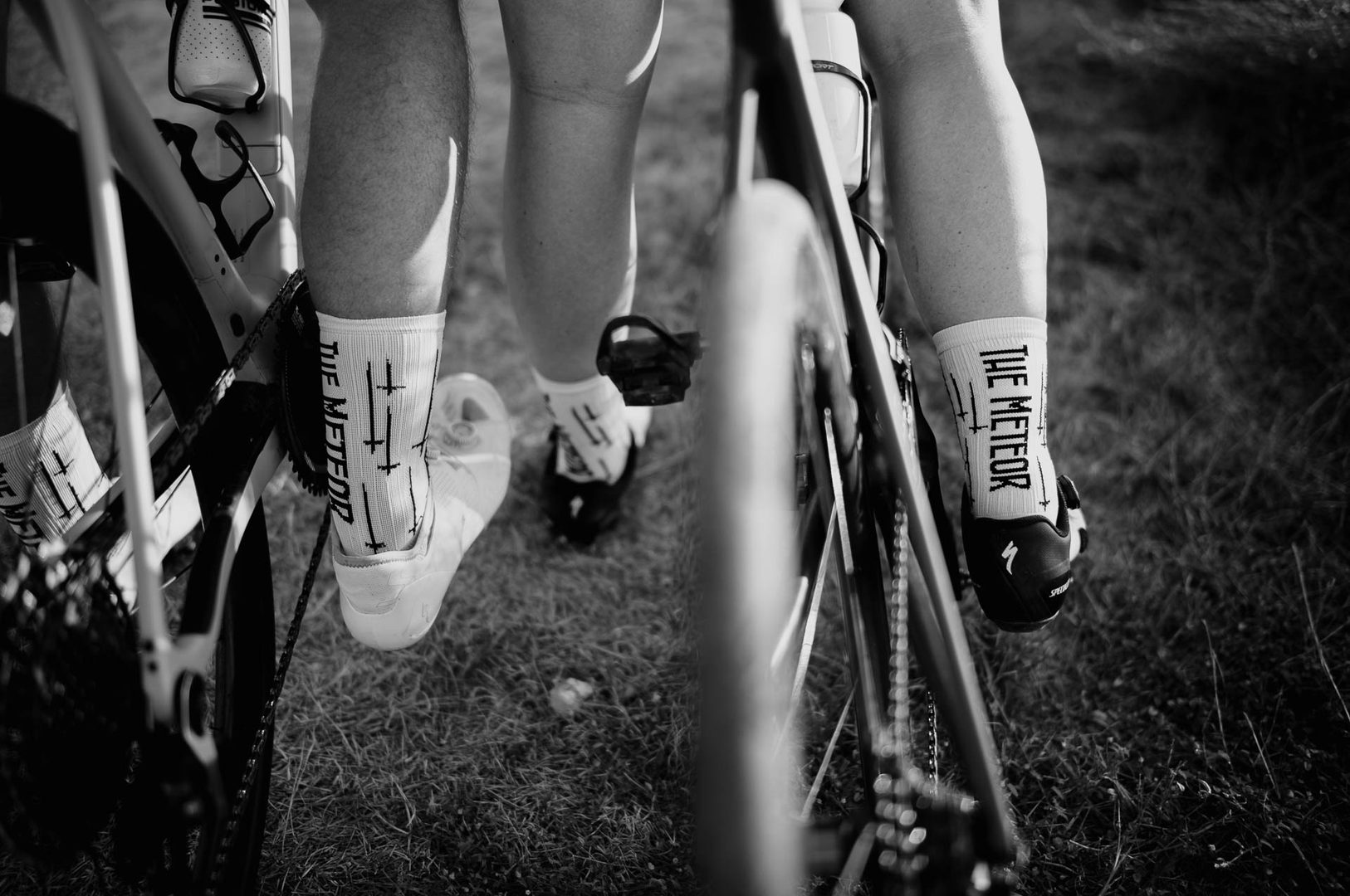 Cyclists wearing matching socks, close-up.